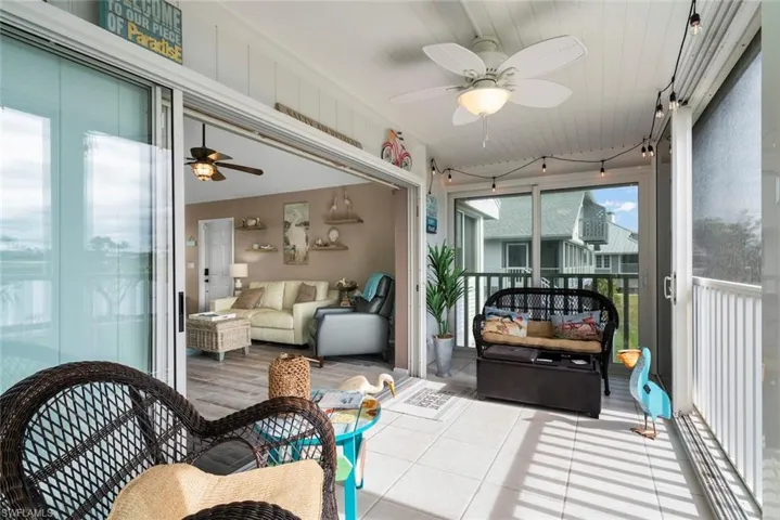 Sunroom / solarium with ceiling fan and wooden ceiling