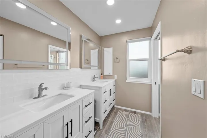 Bathroom with decorative backsplash and vanity
