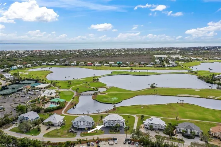 Birds eye view of property with a water view