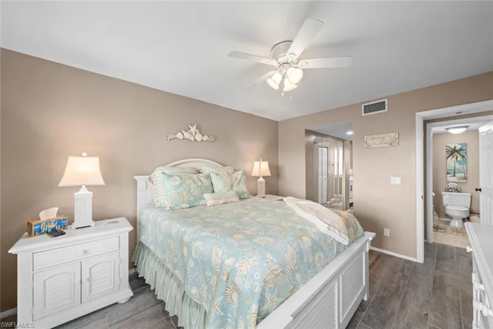 Bedroom featuring ceiling fan and connected bathroom