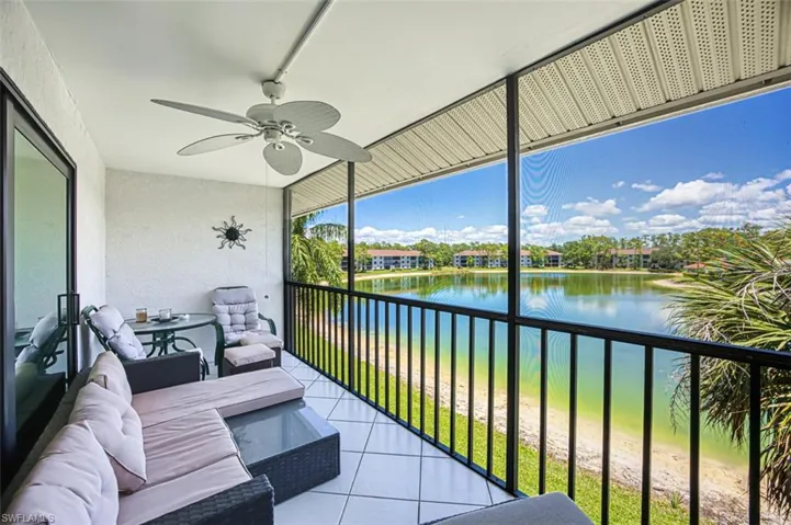 Balcony featuring a ceiling fan, a water view, and an outdoor living space