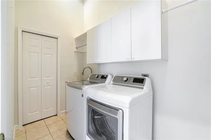 LAUNDRY WITH NEWER WASHER & DRYER.EXTRA CABINET STORAGE & A SET TUB SINK.