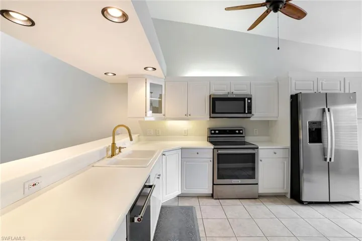 KITCHEN FEATURING WHITE CABINETRY & STAINLESS APPLIANCES