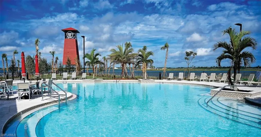 Community pool featuring a patio area and a water view