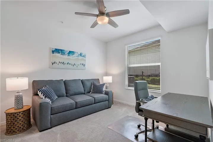 Office space with carpet and a ceiling fan