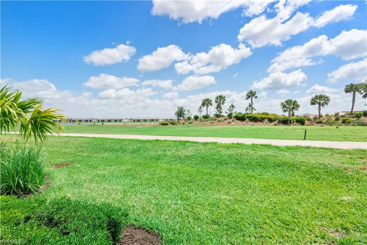 View of community featuring a lawn and a view of countryside