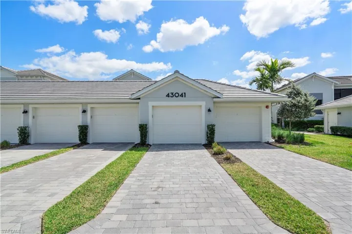 Single story home featuring a tiled roof and stucco siding