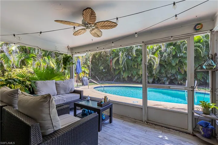 Outdoor pool featuring outdoor lounge area and ceiling fan