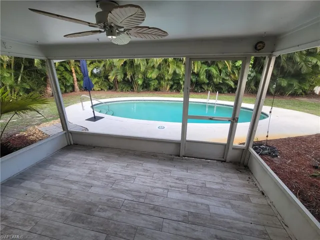 Screened in lanai overlooking backyard & pool