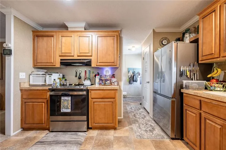 Off the Kitchen is the inside Laundry room with exterior door to rear porch and yard.
