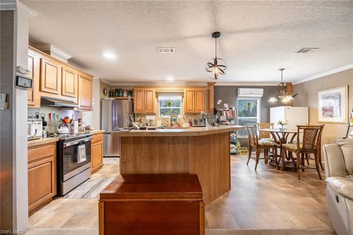 Beautiful and functional Kitchen with Island bar seating, stainless appliances and easy access to the dining space.