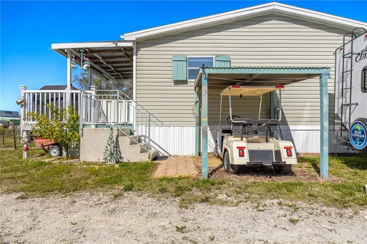 Golf Cart Parking!!!! Golf cart is also negotiable in the sale. Next to this space is 30Amp RV hookup and pad for guests to stay without invading your space.