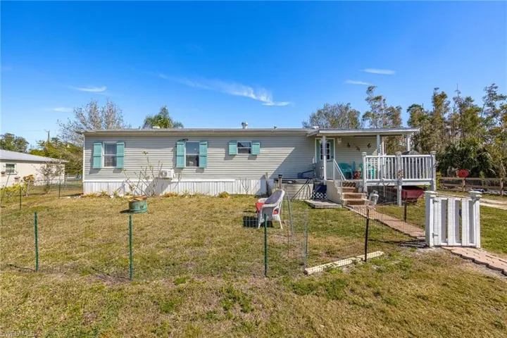 Rear yard with small pet fenced in area.