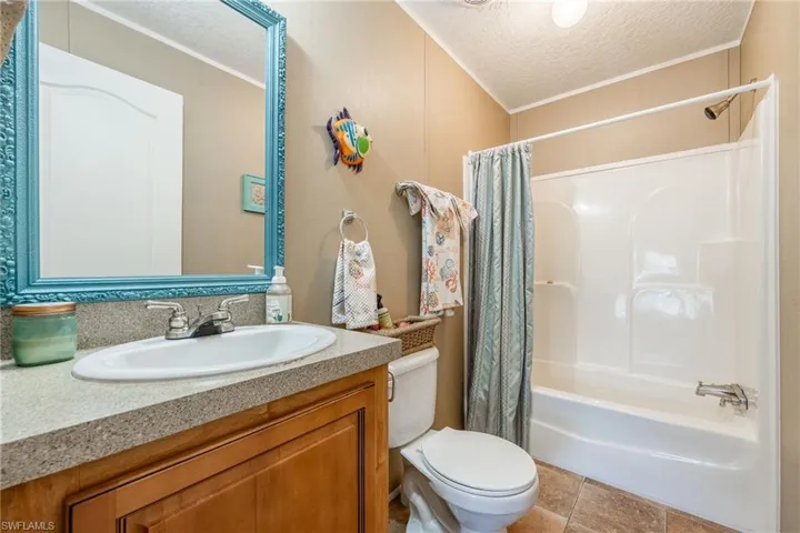 Guest Bath with shower/tub combo is located near Beds 2&3 on the right side of the home.