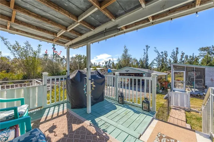From the rear access/Exterior door off Laundry Room, you will find this peaceful back porch. This is gated for small children or pets to go outside without wondering the larger property.