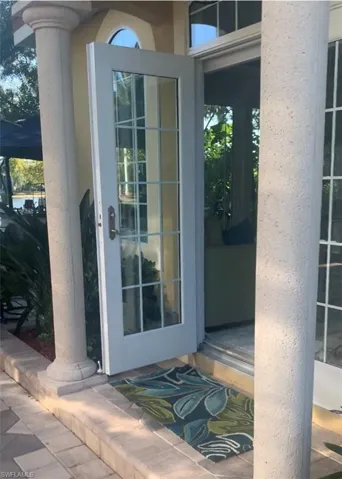 View of exterior entry with stucco siding