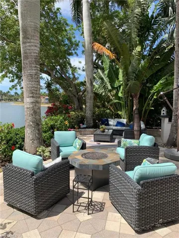View of patio / terrace with an outdoor living space with a fire pit and a water view