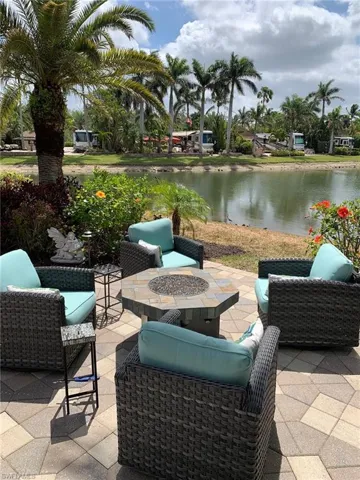View of patio / terrace featuring a water view and an outdoor living space with a fire pit