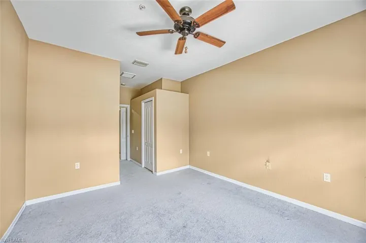 Spare room featuring carpet and a ceiling fan