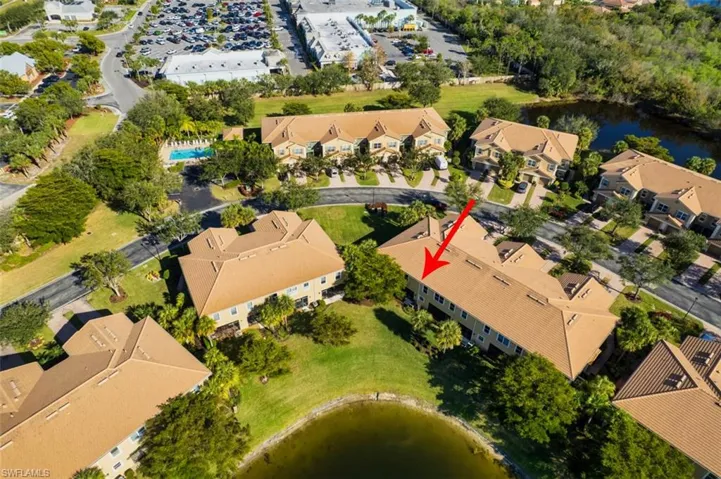 Aerial view of property and surrounding area featuring a large body of water and nearby suburban area
