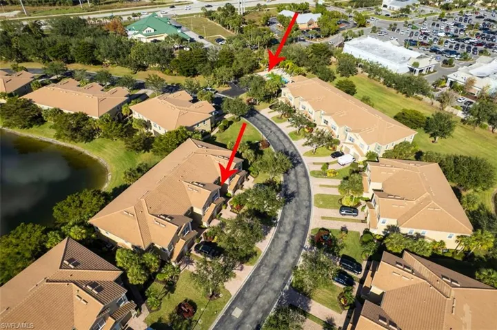 Aerial perspective of suburban area featuring a nearby body of water