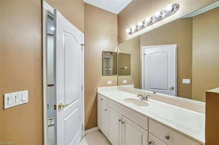 Bathroom with vanity and light tile patterned flooring