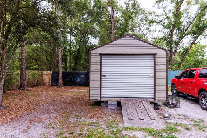 Utility shed with horizontal siding and a roll-up door