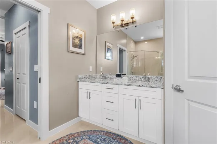 Bathroom featuring vanity, an enclosed shower, and tile patterned floors