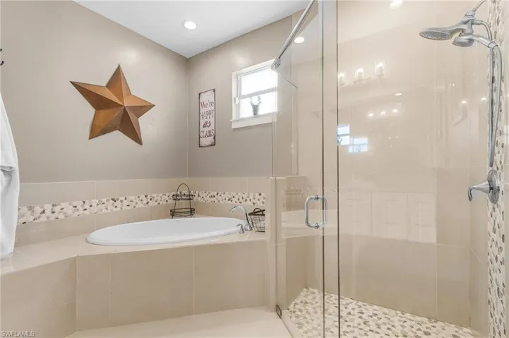 Bathroom featuring separate shower and tub