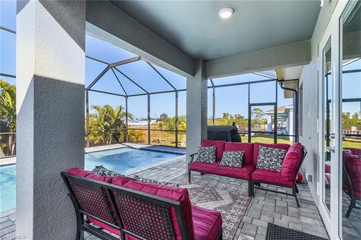 View of pool featuring a lanai, outdoor lounge area, and a patio