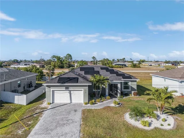 View of front of property with a garage and a front yard
