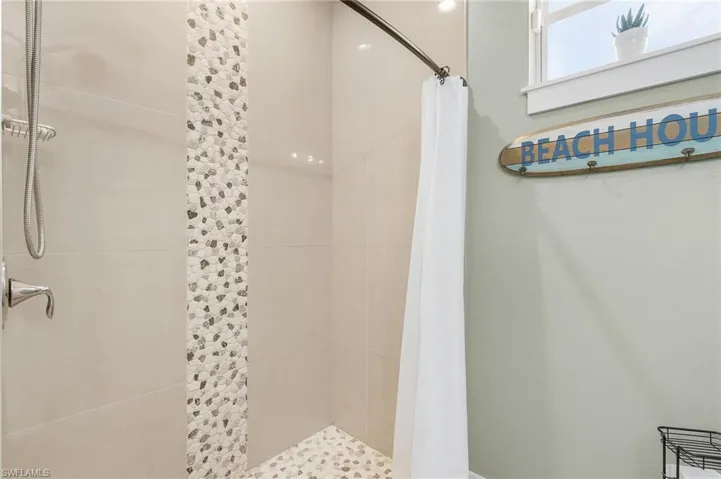 Bathroom featuring curtained shower