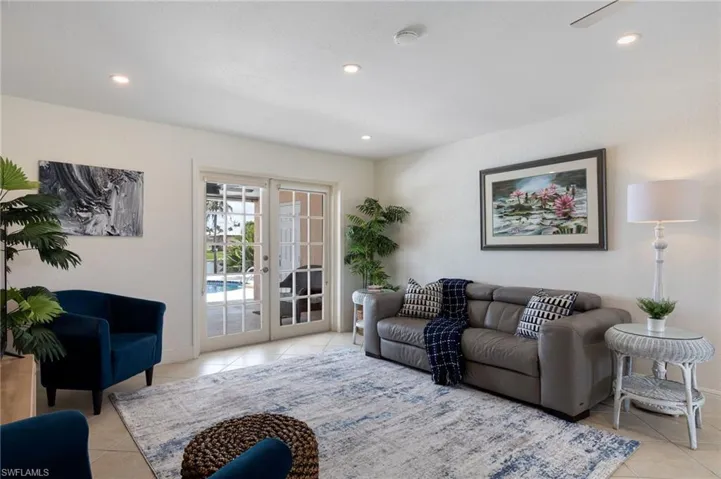 Living area featuring ceramic tile flooring, recessed lighting, and white walls