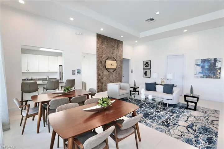 Dining area with a high ceiling and recessed lighting
