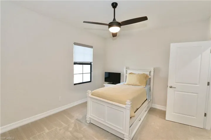 Bedroom with light carpet and ceiling fan