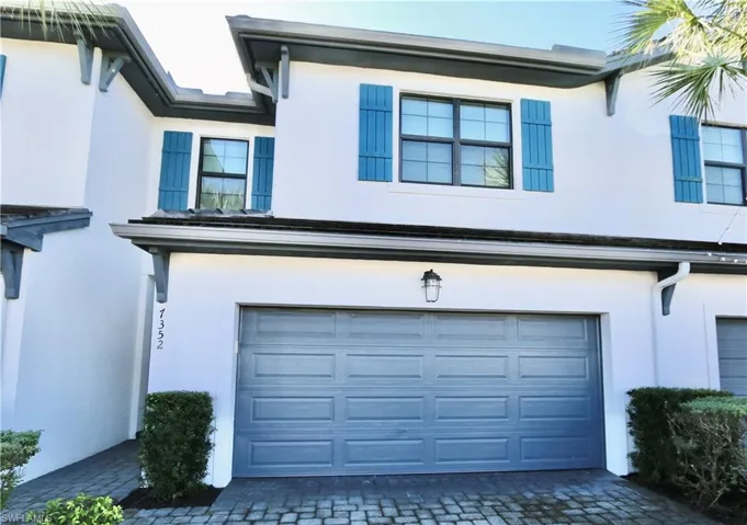 Garage featuring decorative driveway