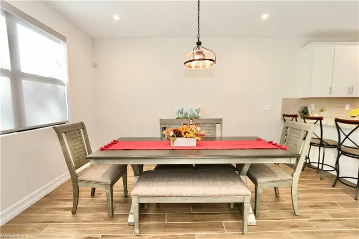 Dining room featuring wood tiled floors and recessed lighting