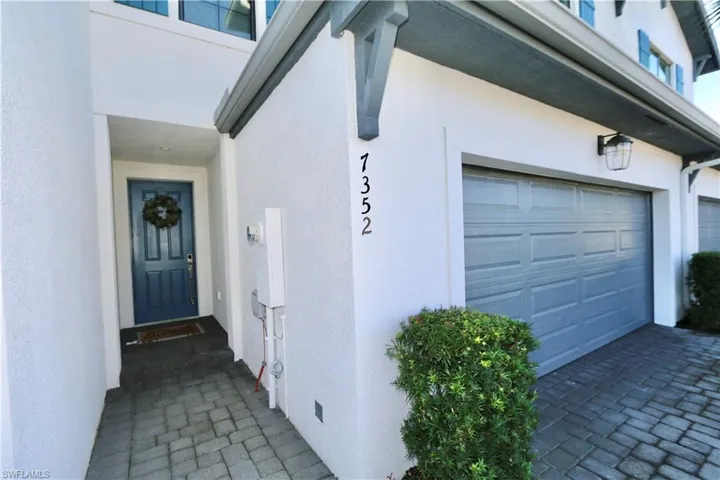 Entrance to property with stucco siding and a garage