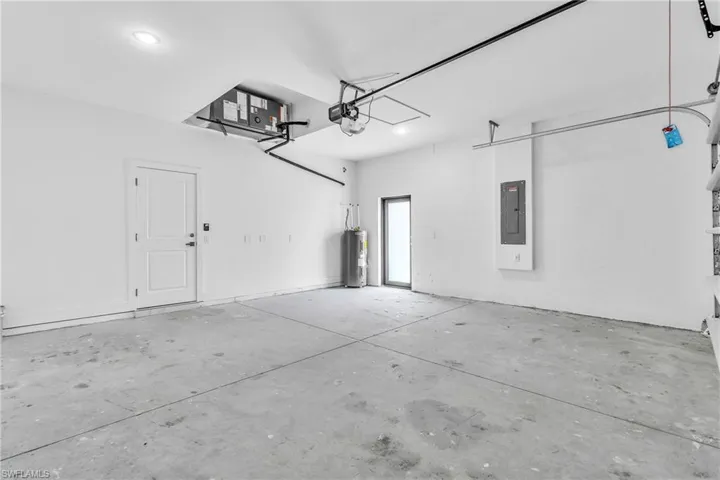 Garage with water heater and electric panel