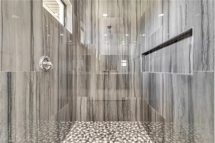 Bathroom featuring a tile shower