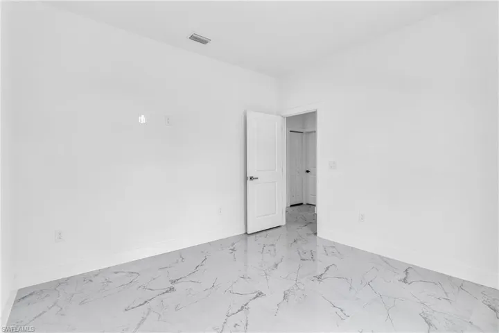 Empty room with light marble finish flooring and baseboards