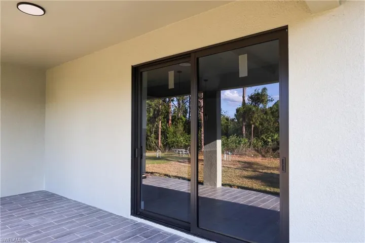 Property entrance featuring stucco siding