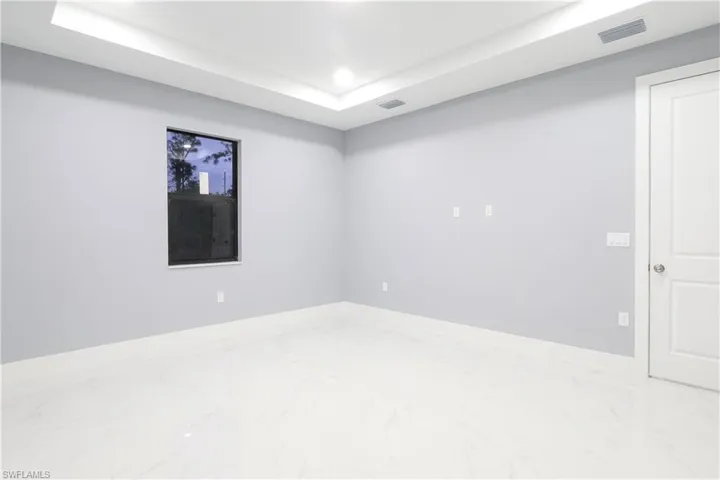 Spare room with recessed lighting and a tray ceiling