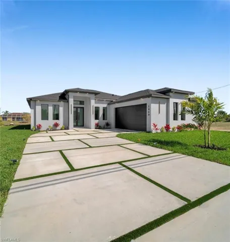 Modern architectural facade featuring a contrasting dark roofline and light-colored stucco