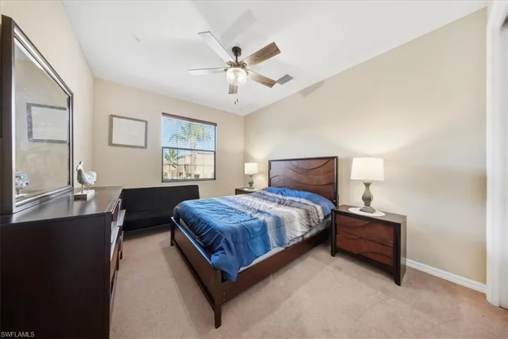 Bedroom featuring light colored carpet and ceiling fan