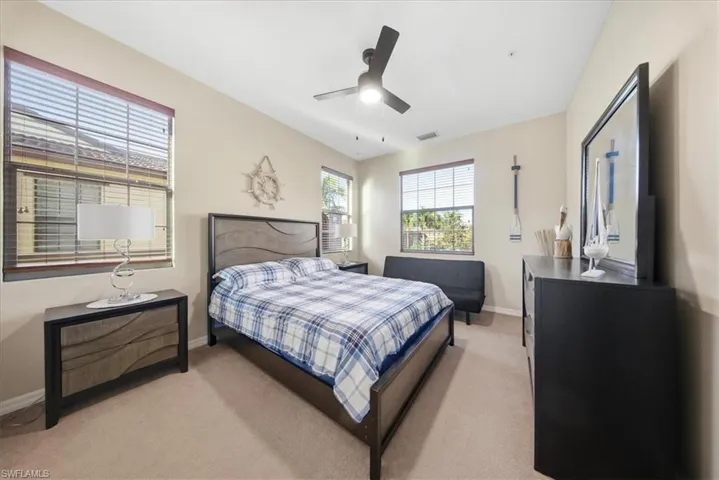 Bedroom with light carpet and ceiling fan