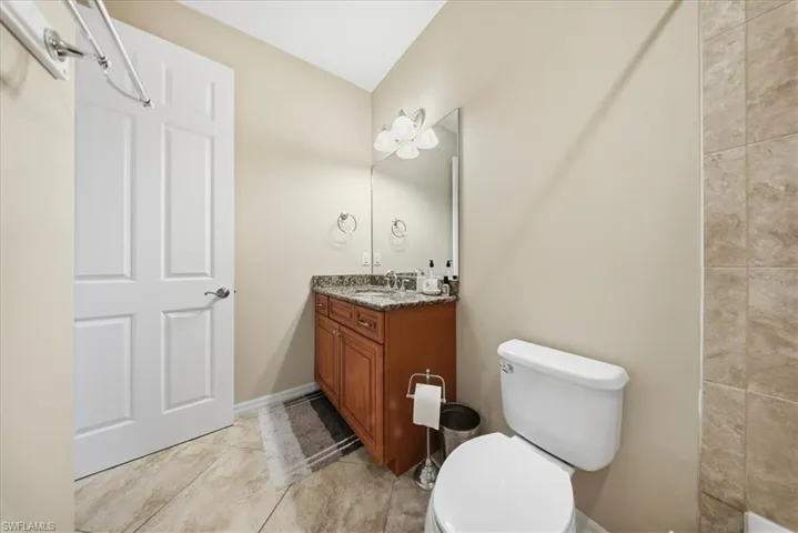 Full bath with vanity and light tile patterned floors