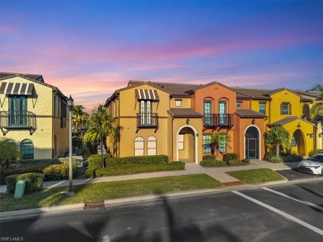 Mediterranean / spanish-style house with a balcony, stucco siding, and a tile roof