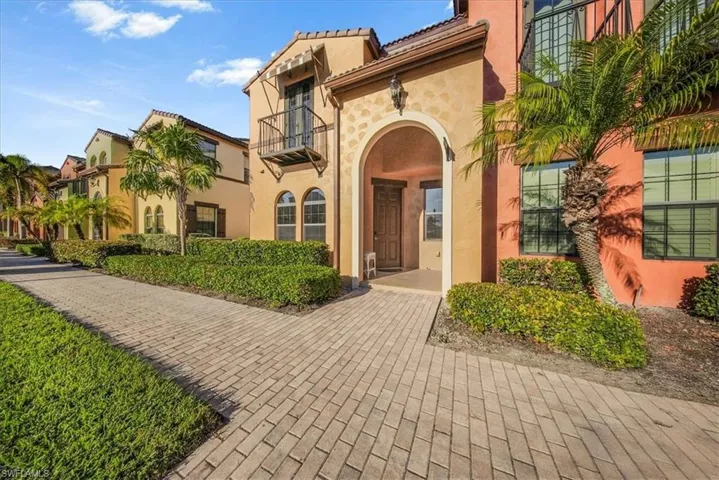 Doorway to property with stucco siding and a tiled roof