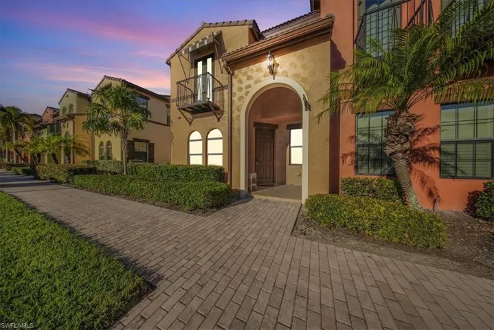 View of exterior entry featuring stucco siding and a tile roof